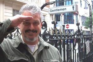 Ned salutes in front of London Gentlemen sign