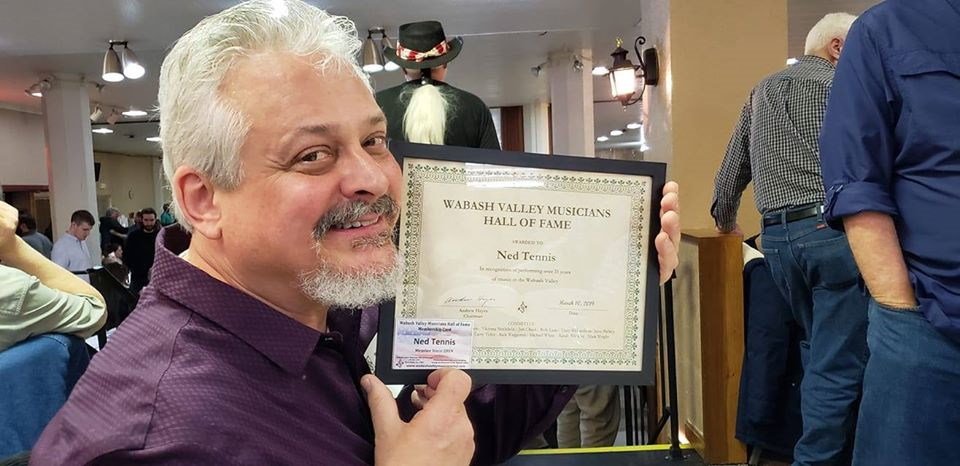 Ned Tennis holding his Wabash Valley Musicians Hall of Fame certificate of membership.